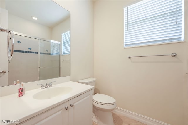 bathroom with an enclosed shower, vanity, toilet, and tile patterned flooring