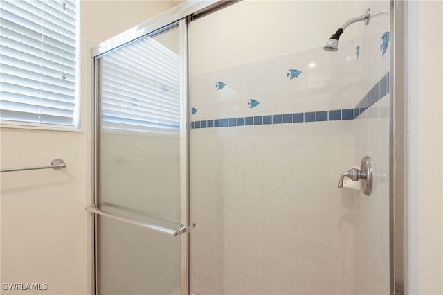 bathroom with a shower with shower door