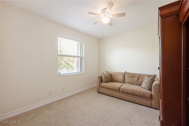 living area with ceiling fan and light carpet