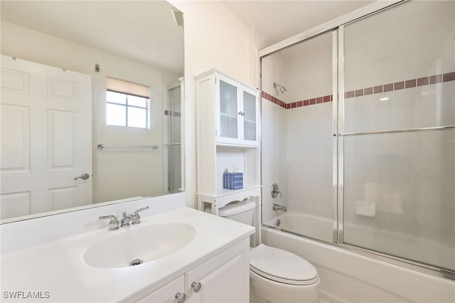 full bathroom featuring toilet, vanity, and shower / bath combination with glass door