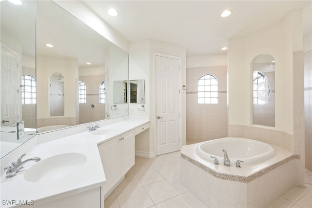 bathroom featuring plus walk in shower, tile patterned floors, and vanity