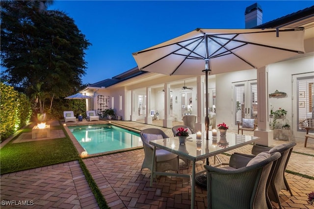 pool with a patio area, french doors, and outdoor dining space