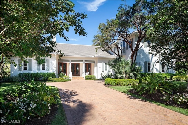 view of front of home featuring decorative driveway and stucco siding