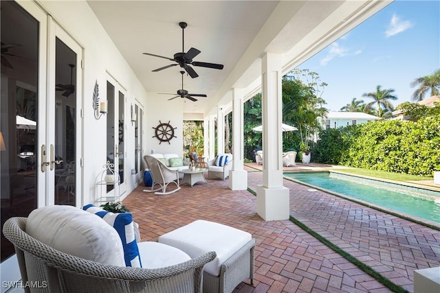 view of patio / terrace featuring ceiling fan, an outdoor pool, and french doors