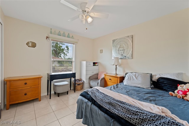 tiled bedroom featuring ceiling fan