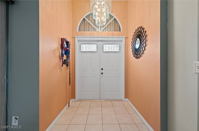 entryway featuring light tile patterned floors and a notable chandelier