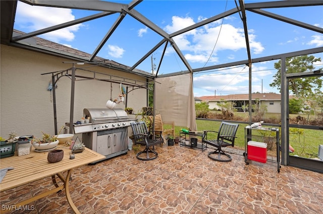 view of patio with grilling area and a lanai