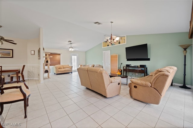 living room with ceiling fan with notable chandelier, vaulted ceiling, and light tile patterned floors