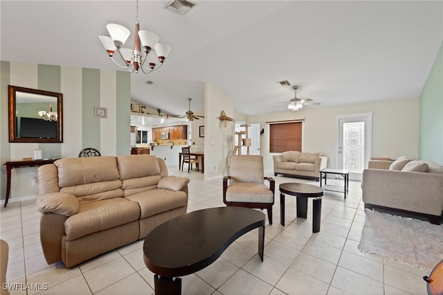 living room featuring lofted ceiling, ceiling fan with notable chandelier, and light tile patterned floors