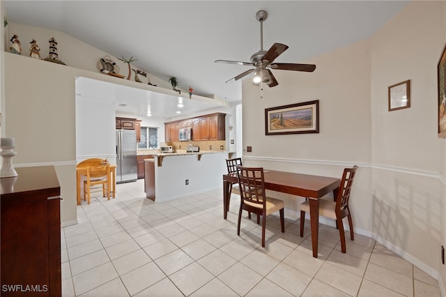 dining space featuring vaulted ceiling, ceiling fan, and light tile patterned flooring