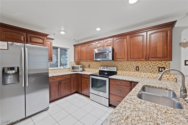 kitchen with appliances with stainless steel finishes, sink, backsplash, ornamental molding, and light tile patterned floors