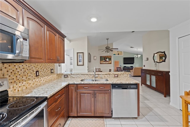 kitchen featuring sink, vaulted ceiling, kitchen peninsula, stainless steel appliances, and backsplash