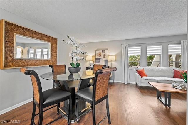 dining area featuring hardwood / wood-style floors and a textured ceiling