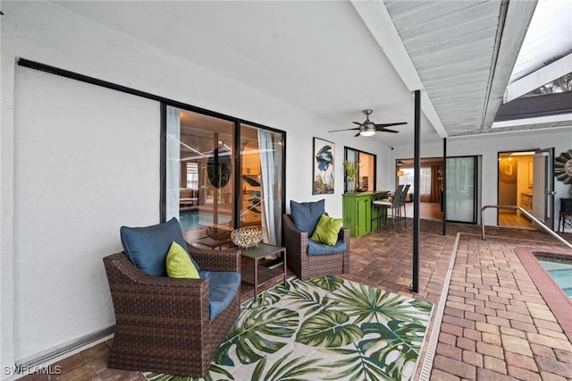 view of patio / terrace featuring a bar and ceiling fan