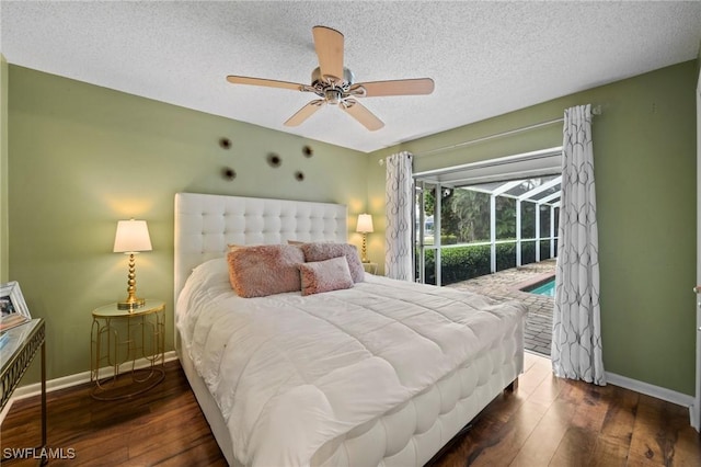 bedroom featuring ceiling fan, dark hardwood / wood-style floors, a textured ceiling, and access to outside