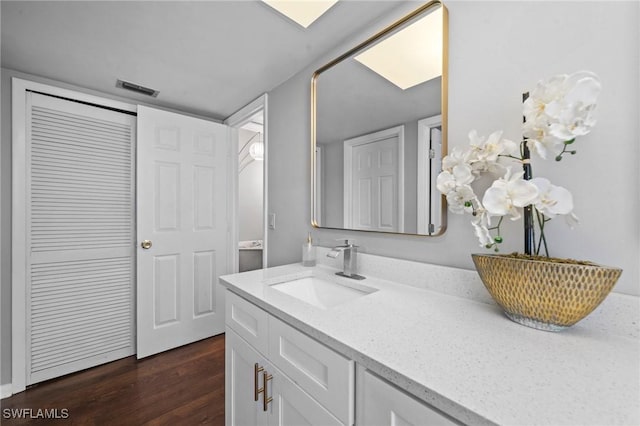 bathroom featuring hardwood / wood-style flooring and vanity