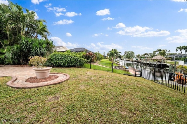 view of yard featuring a water view and a dock