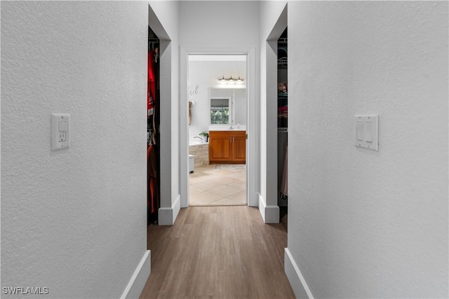 corridor with light hardwood / wood-style flooring