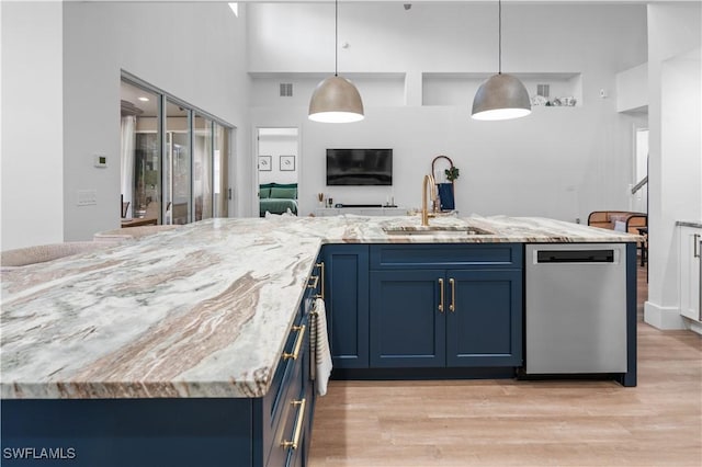 kitchen with dishwasher, blue cabinets, decorative light fixtures, and sink