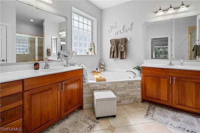 bathroom featuring tile patterned floors, vanity, and plus walk in shower