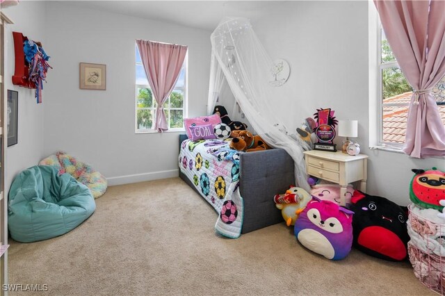 carpeted bedroom with multiple windows