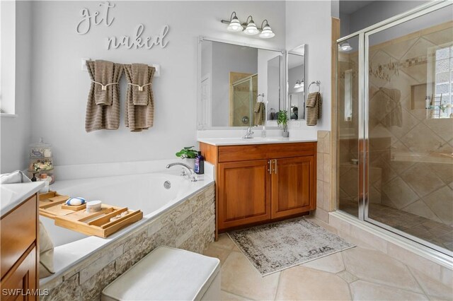 bathroom with shower with separate bathtub and vanity