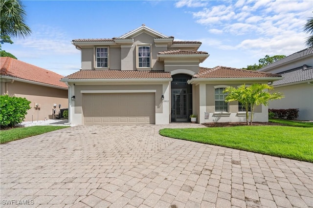 mediterranean / spanish-style house with a front yard and a garage