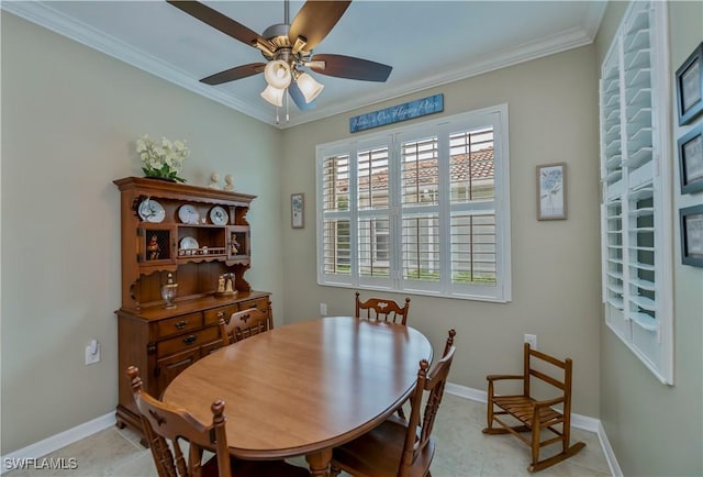 tiled dining room with ceiling fan and crown molding