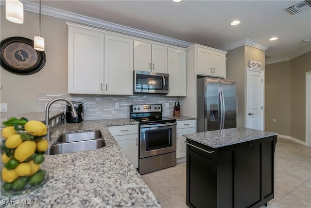 kitchen featuring backsplash, sink, appliances with stainless steel finishes, ornamental molding, and white cabinets