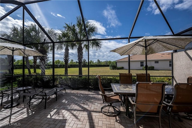 view of patio / terrace featuring a lanai