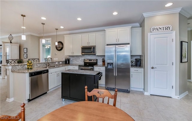 kitchen featuring stainless steel appliances, pendant lighting, white cabinets, and kitchen peninsula