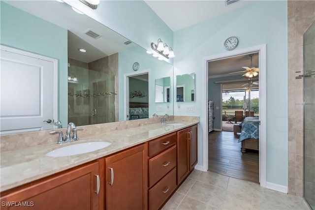 bathroom with an enclosed shower, vanity, ceiling fan, and tile patterned floors