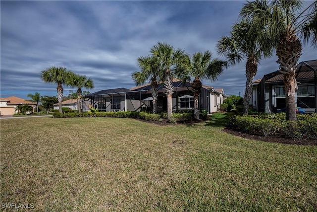 view of front of home with a lanai and a front yard