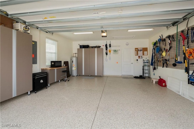 garage with electric water heater, a garage door opener, and electric panel