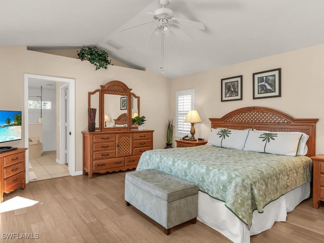 bedroom featuring connected bathroom, ceiling fan, light hardwood / wood-style floors, and lofted ceiling