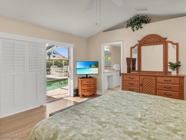 bedroom featuring lofted ceiling, ensuite bathroom, light hardwood / wood-style flooring, ceiling fan, and access to exterior