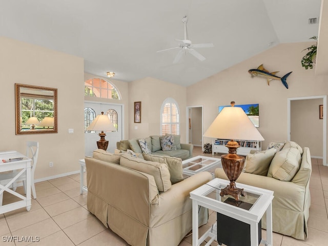 tiled living room featuring ceiling fan and vaulted ceiling