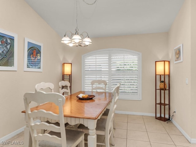 tiled dining space featuring vaulted ceiling and a notable chandelier