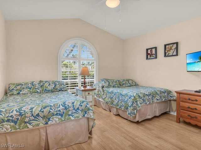 bedroom featuring ceiling fan, light hardwood / wood-style floors, and vaulted ceiling