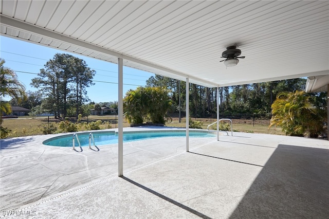 view of swimming pool with ceiling fan and a patio area