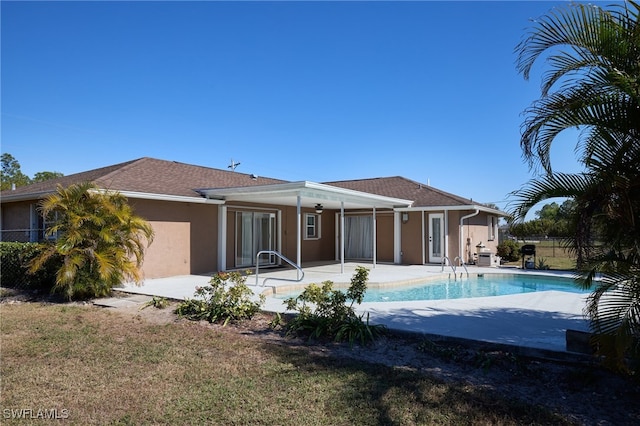 back of house with a patio area and a yard