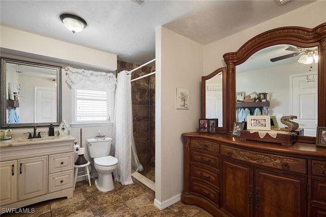 bathroom featuring a shower with curtain, vanity, toilet, and ceiling fan