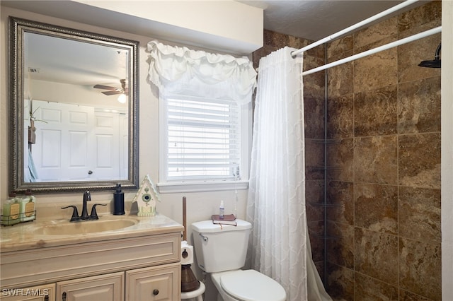 bathroom with a shower with curtain, vanity, toilet, and ceiling fan