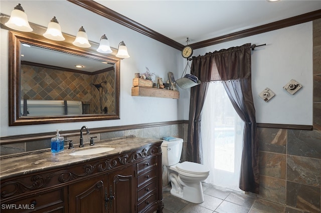 bathroom featuring vanity, toilet, tile walls, and crown molding