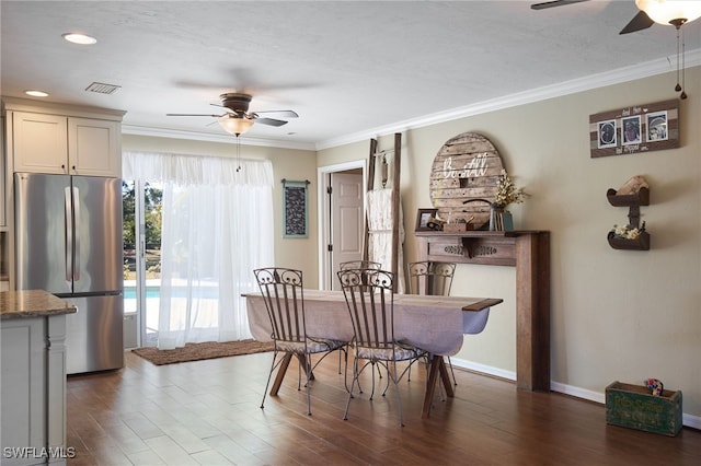 dining area with dark hardwood / wood-style flooring, ceiling fan, and crown molding