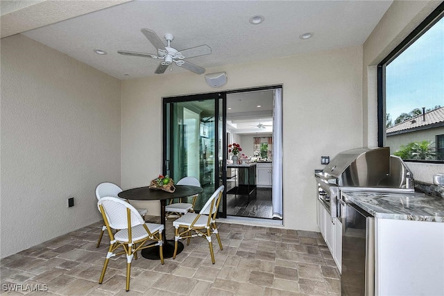 view of patio featuring a grill, area for grilling, and ceiling fan