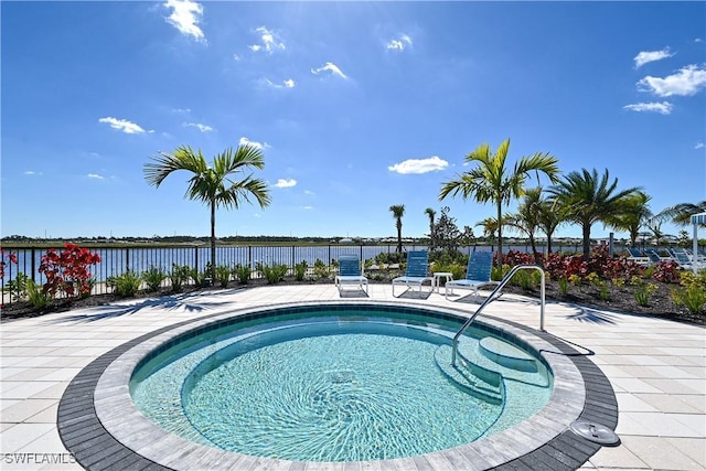 view of pool with a water view and a community hot tub