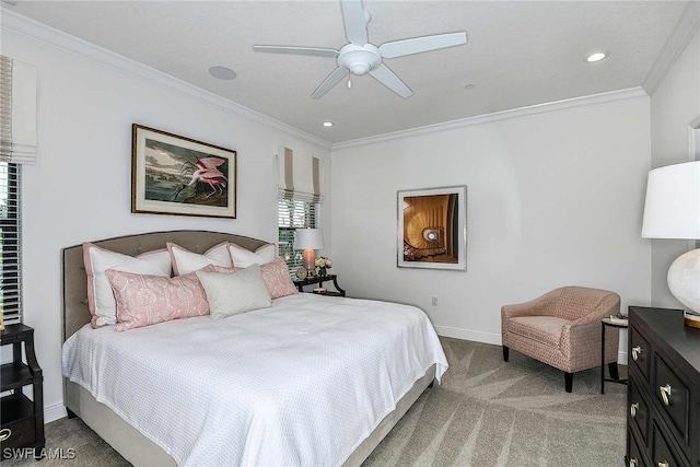 carpeted bedroom featuring ceiling fan and crown molding