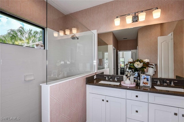 bathroom featuring vanity, walk in shower, and tile walls