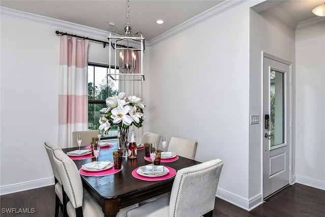 dining room featuring dark hardwood / wood-style flooring, an inviting chandelier, and ornamental molding